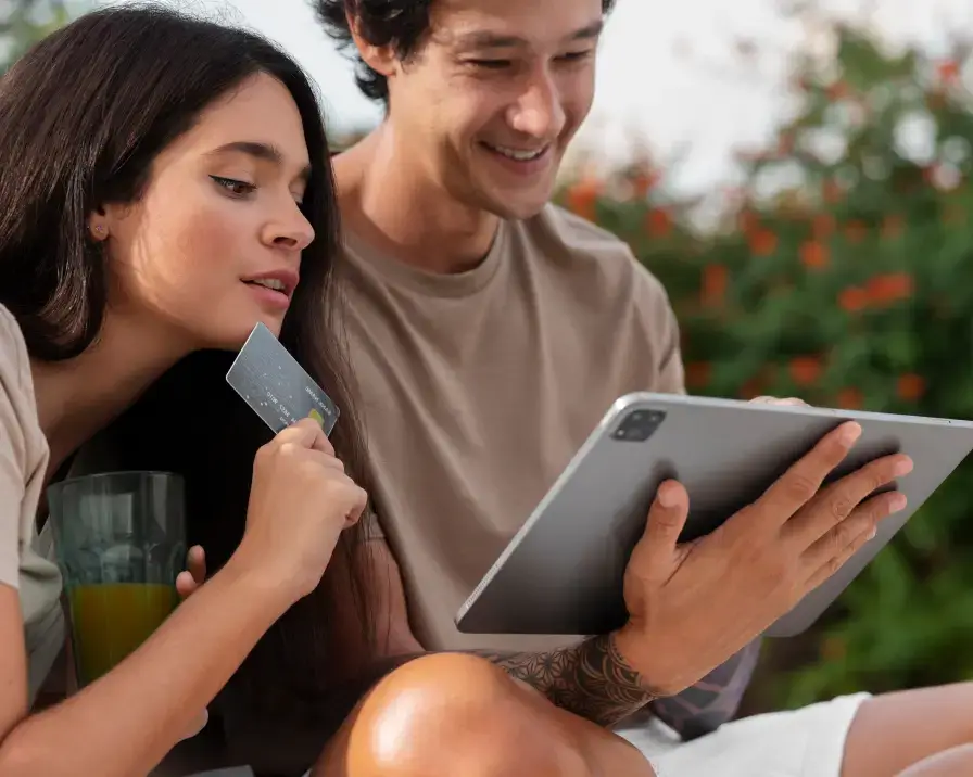 Couple looking at tablet with credit card