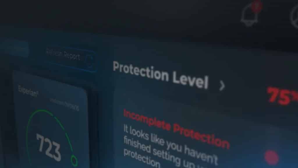 Snapshot of new IdentityIQ website. Close-up of a computer screen showing a credit score interface. The screen displays a score of 723 and a message about incomplete protection, suggesting the setup of a protection feature is not finished. The "Protection Level" is also highlighted at 75%.